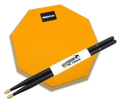 Immagine prodotto di keepdrum practice pad arancione con bacchette nere