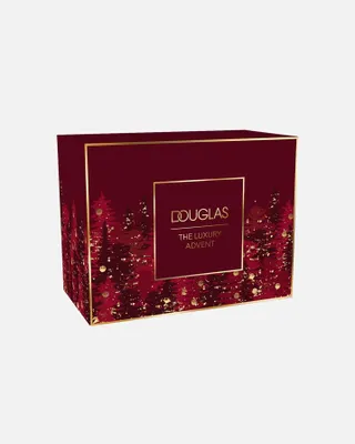 A red and gold advent calendar box with a forest and snow design.