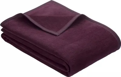 A folded dark purple blanket is shown on a white background.