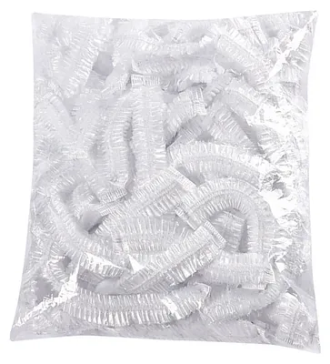 A pile of clear plastic disposable shower caps in a bag.