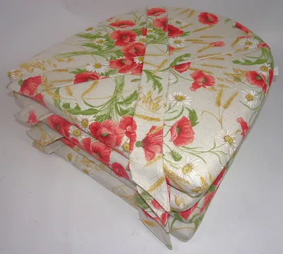 A stack of four chair cushions with a floral pattern of poppies and daisies on a light beige background.