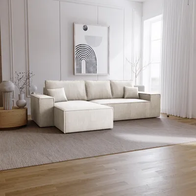 A modern living room with a beige sectional sofa, a rug, and a framed abstract artwork on the wall.