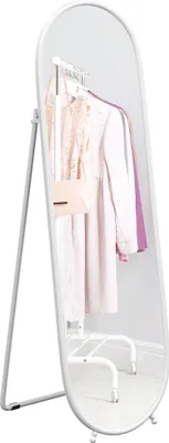 A full-length mirror with a stand, displaying clothes and a handbag on a rack behind it.