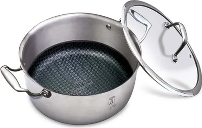 A stainless steel pot with a honeycomb pattern on the inside and a glass lid is shown.