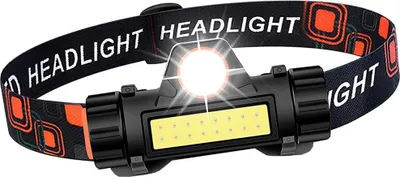 A close-up shot of a black LED headlamp with an orange and black patterned strap.