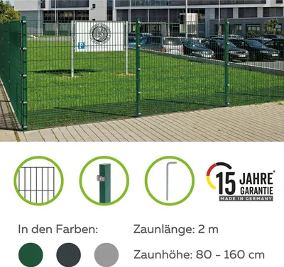 A green metal fence in front of a building and a parking lot, with marketing information below.