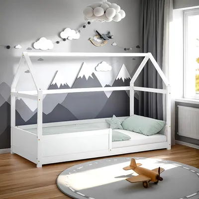 A child's bedroom with a house-shaped bed, mountain-themed wall art, and a toy airplane on a rug.