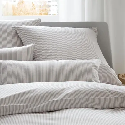 Close-up view of striped bedding on a bed.