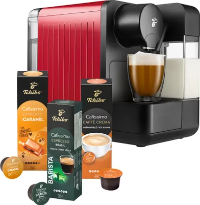 A red Tchibo Cafissimo coffee machine with coffee pods and a glass of coffee.