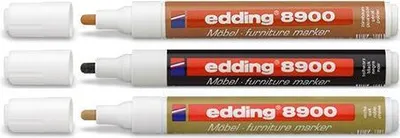 Three furniture markers of different colors, with their caps off.