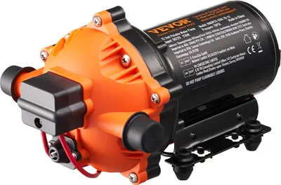 A 12-volt portable water pump with an orange and black casing, mounted on a black bracket with rubber feet.