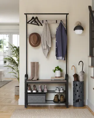 An entryway with a coat rack and shoe storage unit.
