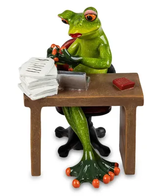 A decorative figurine of a frog sitting at a desk, working on a laptop.