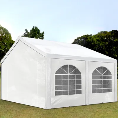 A white party tent set up on a grassy lawn with trees in the background.