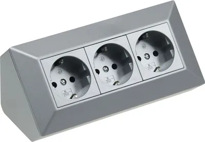 A silver-colored power strip with three outlets.