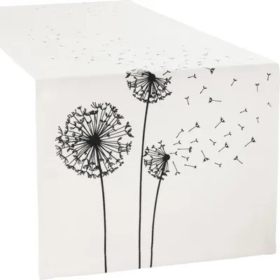 A white table runner with a black dandelion print.