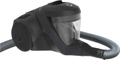 A dark gray and transparent canister vacuum cleaner with a gray hose attached, shown from a side angle on a white background.