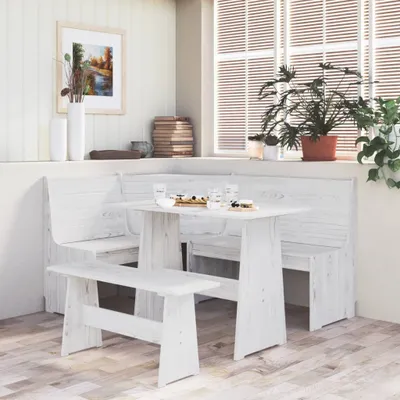 A dining set with a table and benches in a bright room with a window.
