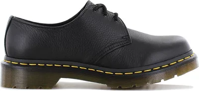 A side view of a black Dr. Martens shoe.