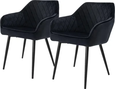 Two black velvet dining chairs with diamond tufting and black metal legs, shown against a white background.