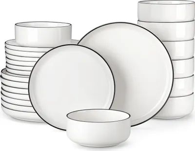 A set of white ceramic dishes with a thin black rim, neatly arranged against a white background.