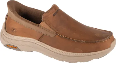 A single brown Skechers slip-on shoe is shown against a white background.