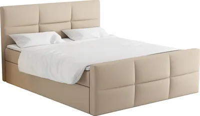 A beige upholstered boxspring bed with a headboard and two pillows.
