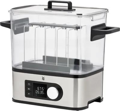 A silver and clear sous vide cooker with a digital display.