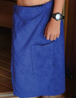 A person wearing a blue towel kilt in what appears to be a sauna or changing room.