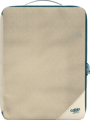 A beige packing cube with teal trim and a small logo in the bottom right corner.