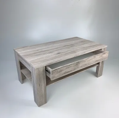 A light-colored wooden coffee table with an open drawer, set against a plain background.