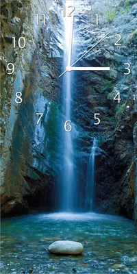 Produktbild von Wallario Design Wanduhr Wasserfall bei Sonneneinfall aus Echtglas, Größe 30 x 60 cm