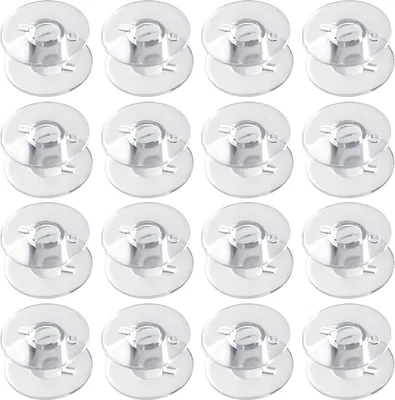 A grid of clear plastic sewing machine bobbins.