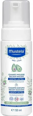 A white bottle of Mustela baby shampoo with green leaf accents and avocado illustrations.
