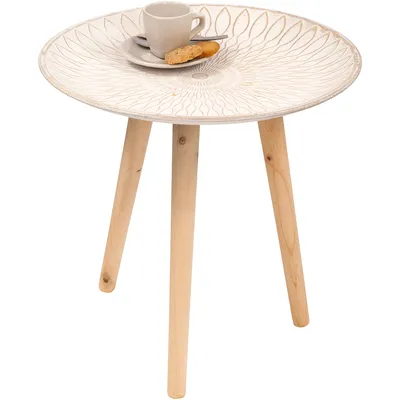 A small round side table with a decorative top and three wooden legs, with a cup and saucer and a cookie on top.