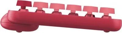 A close-up side view of a red mechanical keyboard with pink keycaps.