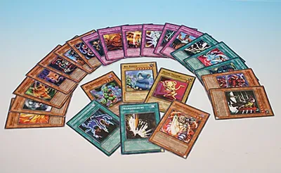 A collection of Yu-Gi-Oh! trading cards arranged in a semi-circle on a light blue and white background.