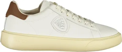 A white leather sneaker with brown accents and a cream-colored sole.