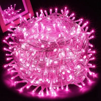 A tightly wound ball of pink LED string lights against a black background.