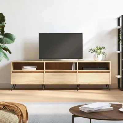 A modern living room setup featuring a TV stand with a television and decorative items.
