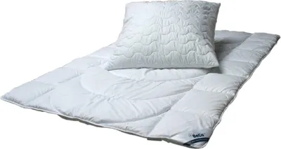 A white duvet and pillow set laid out on a white background.