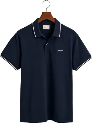 A dark blue Gant polo shirt is displayed on a hanger against a white background.