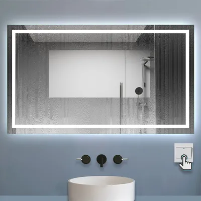 A bathroom scene featuring a lit mirror above a sink with faucets and a wall switch.
