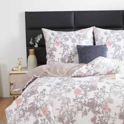 A close-up view of a bed with floral patterned bedding.