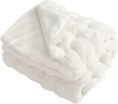 A folded white plush blanket.