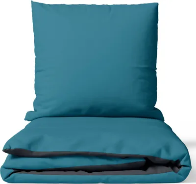 A folded duvet and pillow in teal and anthracite.