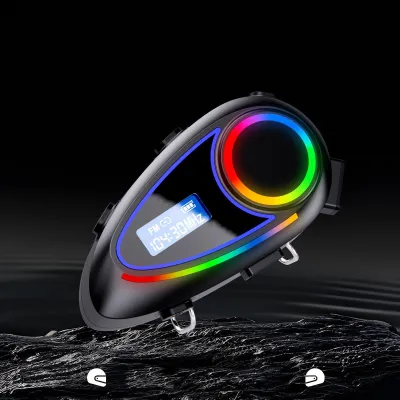 A black motorcycle helmet communication system with colorful LED lights and an LCD screen is displayed against a dark background.