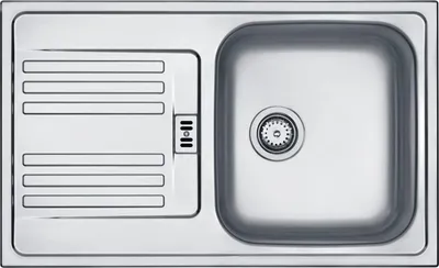 A top-down view of a stainless steel kitchen sink with a drainboard.