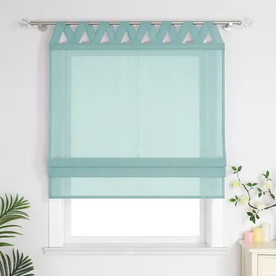 A teal roman blind with a decorative top edge is shown hanging on a window.