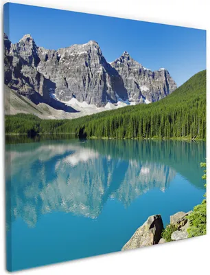 Produktbild von Wallario Premium Leinwandbild Tiefblauer See mit Bergpanorama und Wäldern  Kanada in Größe 50 x 50 cm